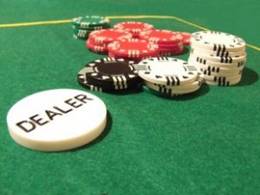 A few stacks of poker chips and the Dealer button on a lovely felt table